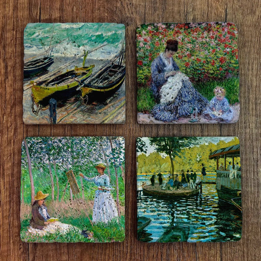 Set of four Coasters with artistic designs on a wooden surface