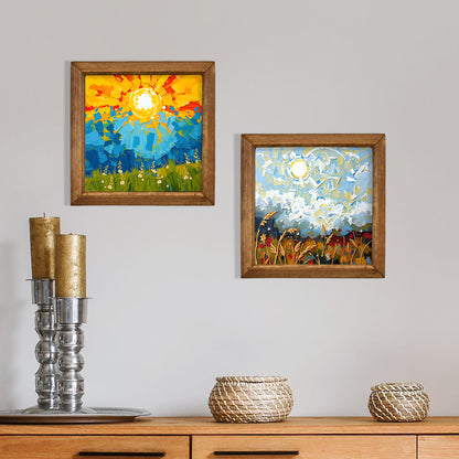 Two framed artworks on a wall above a wooden cabinet with decorative items.