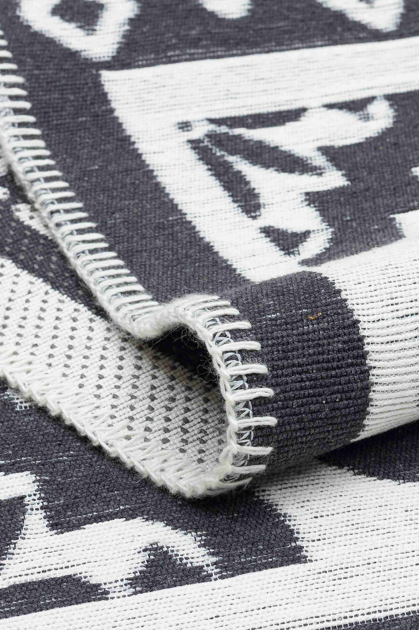 Arya Neo Black White Rug - Folded to Show Pattern and Texture | Artistry Home