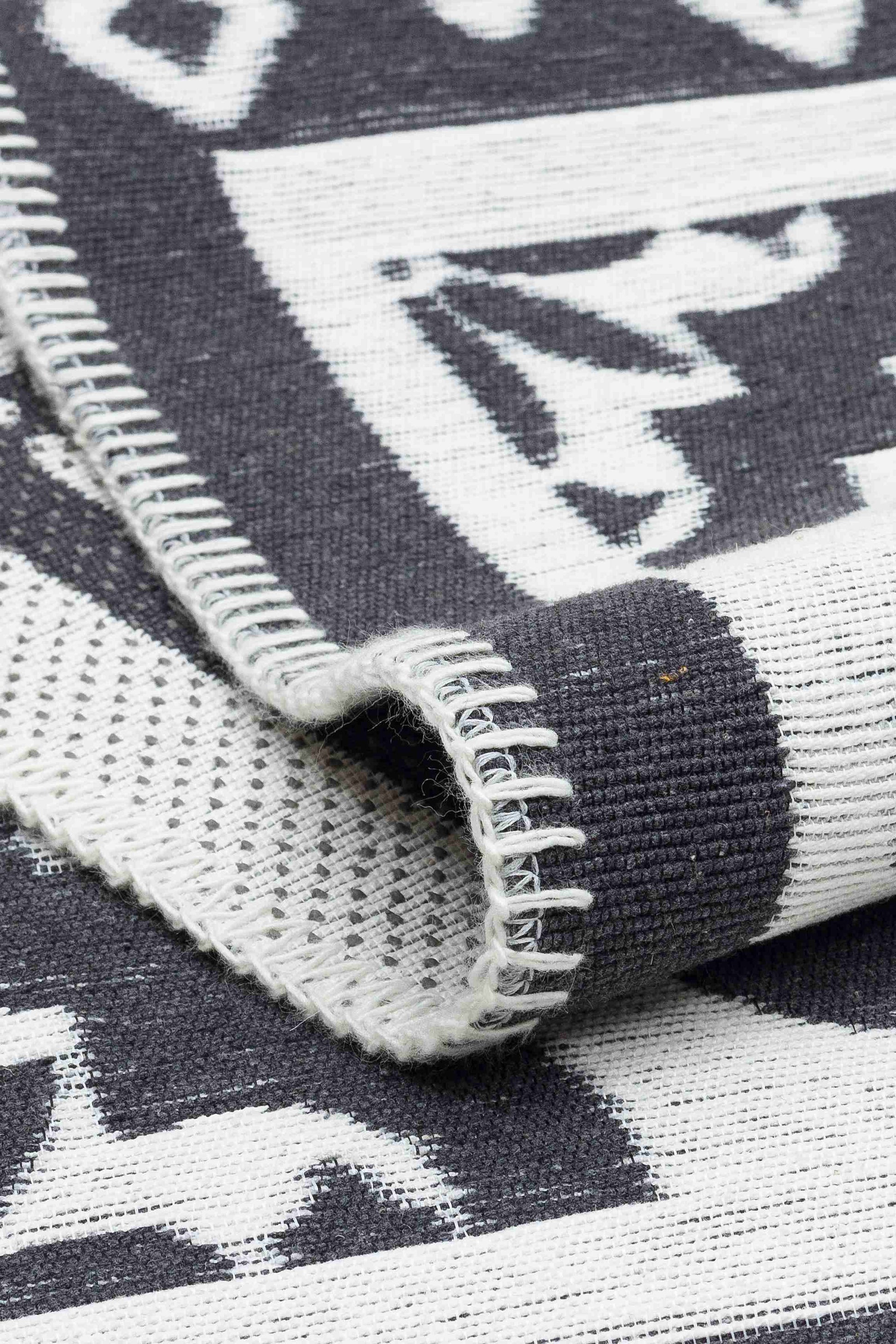 Arya Neo Black White Rug - Folded to Show Pattern and Texture | Artistry Home
