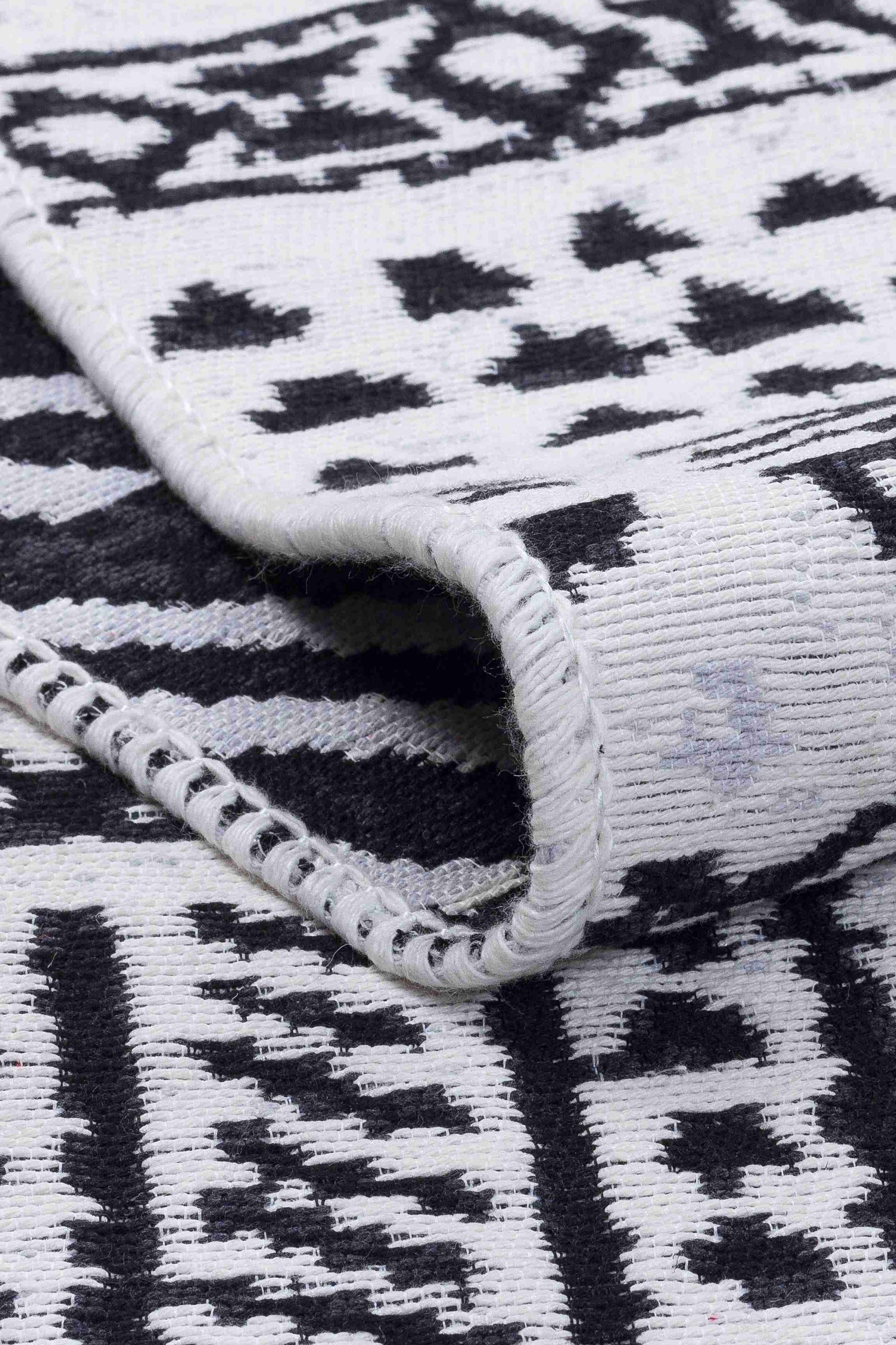Arya Black Rug - Folded to Show Pattern and Texture | Artistry Home