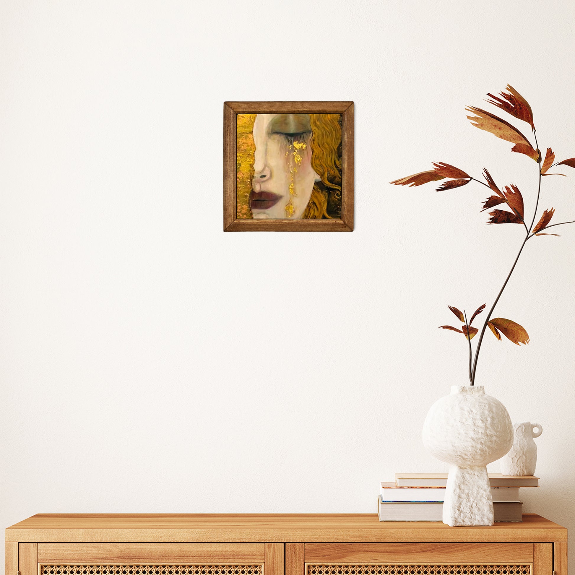 Framed artwork on a wall above a wooden console table with decorative items.