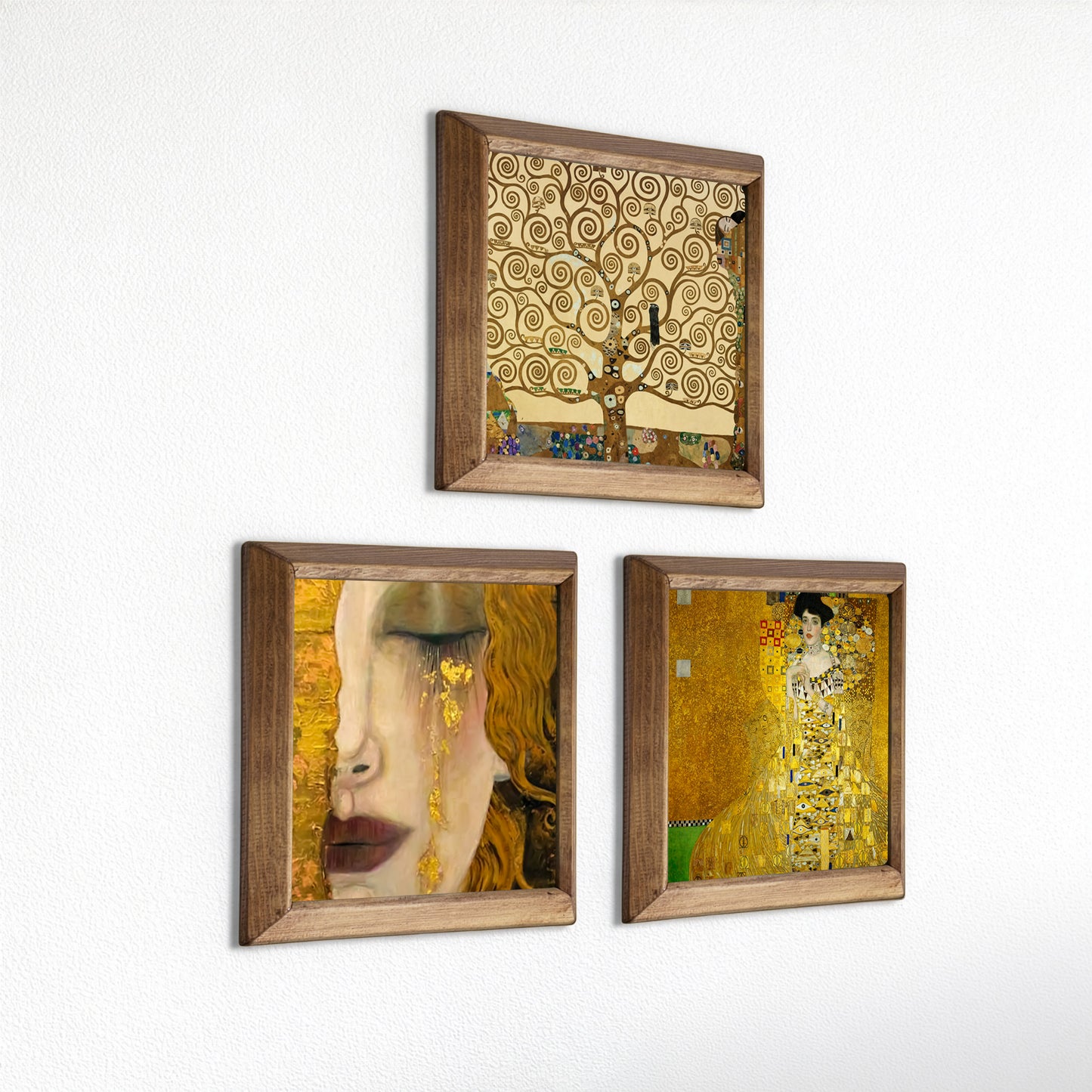 Three framed artworks inspired by Gustav Klimt on a white wall.