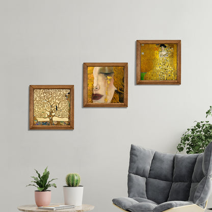 Framed artworks on a wall above a sofa with plants