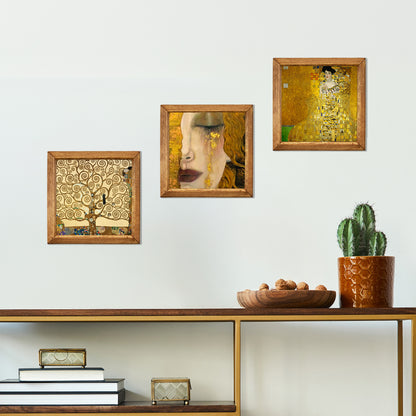 Decorative wall art pieces on a shelf with a cactus plant.