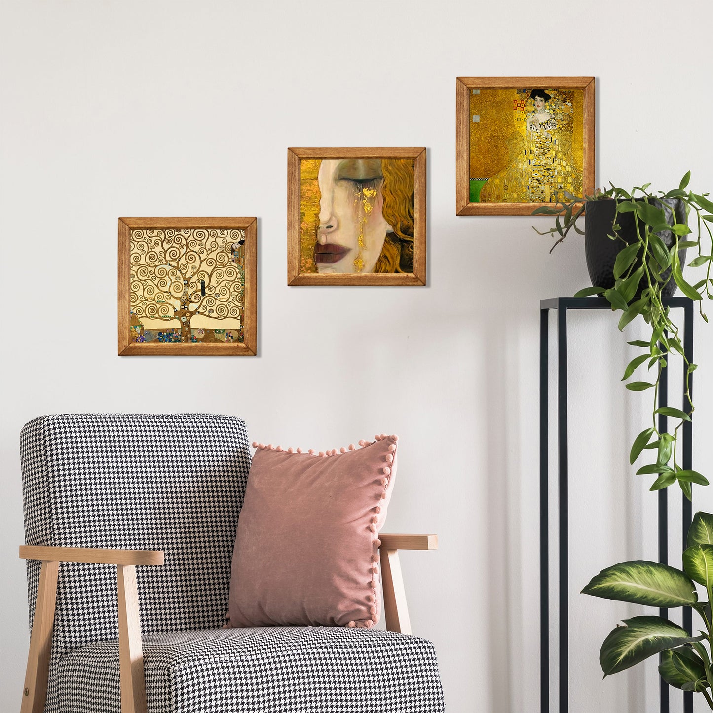 Decorative wall art above a chair with a pink pillow, against a white wall.