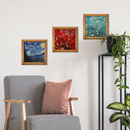 Chair with a pink pillow and framed artworks on a wall