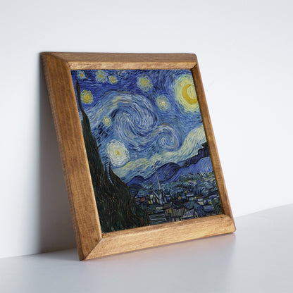 Framed artwork resembling 'Starry Night' by Van Gogh on a white surface.