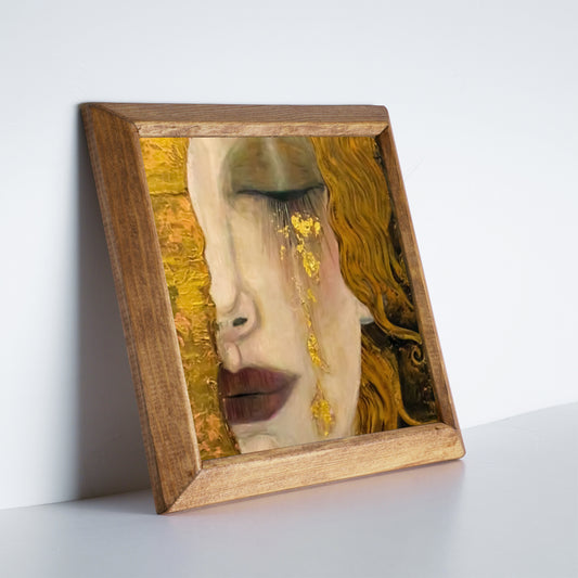 Framed artwork with a stylized face on a white surface