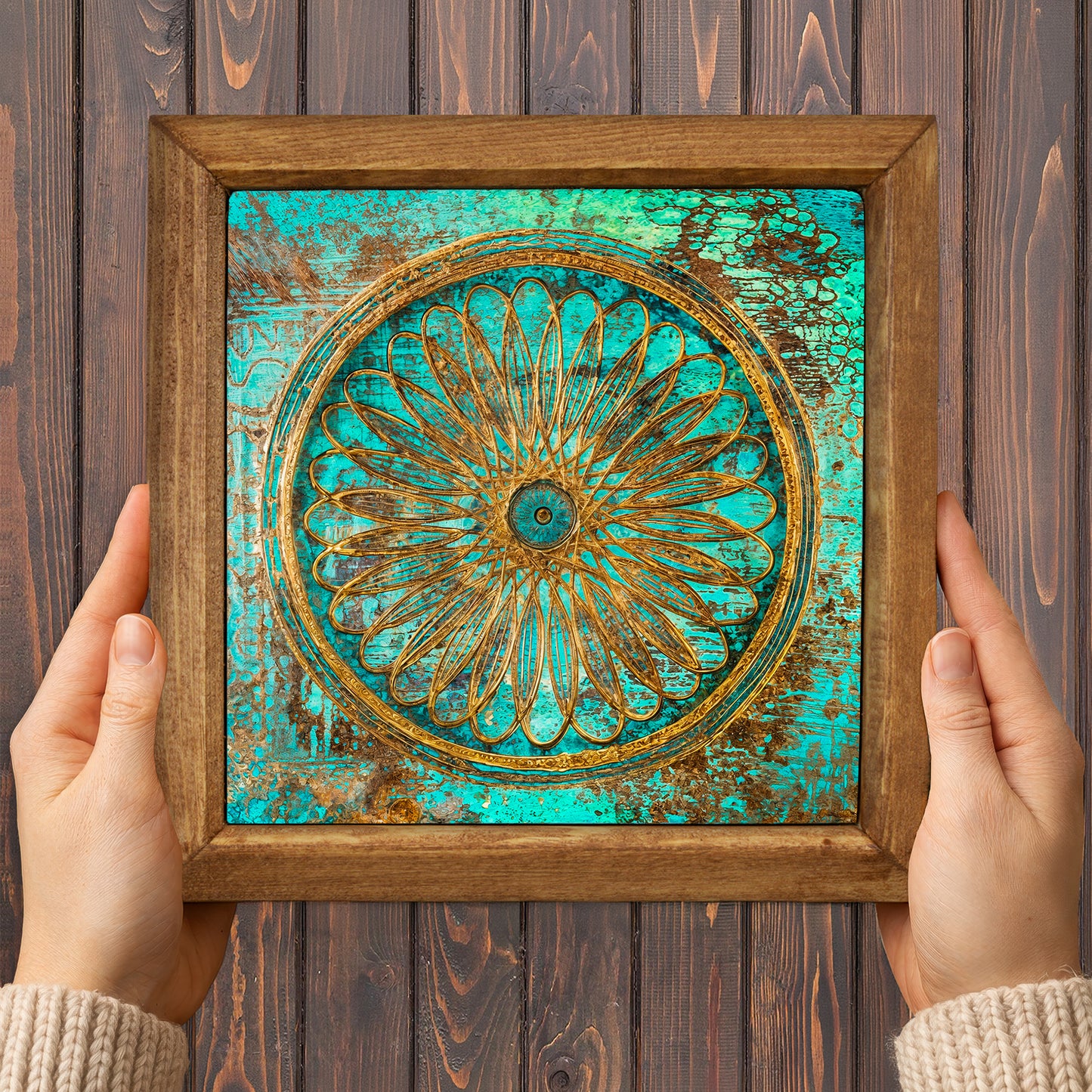 Framed decorative artwork with a floral design on a wooden background
