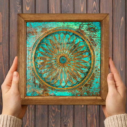 Framed decorative artwork with a floral design on a wooden background