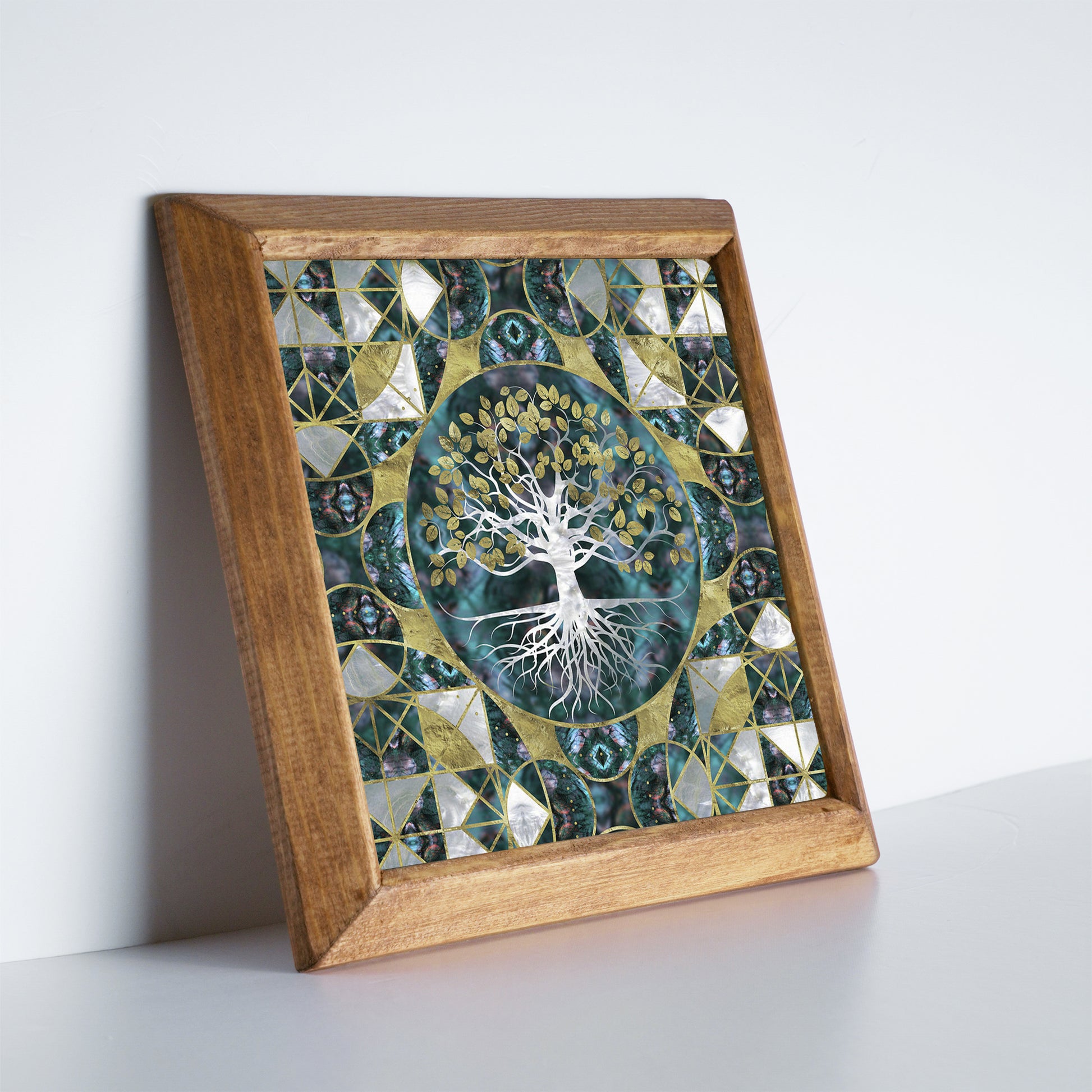 Framed artwork with a tree design on a white surface