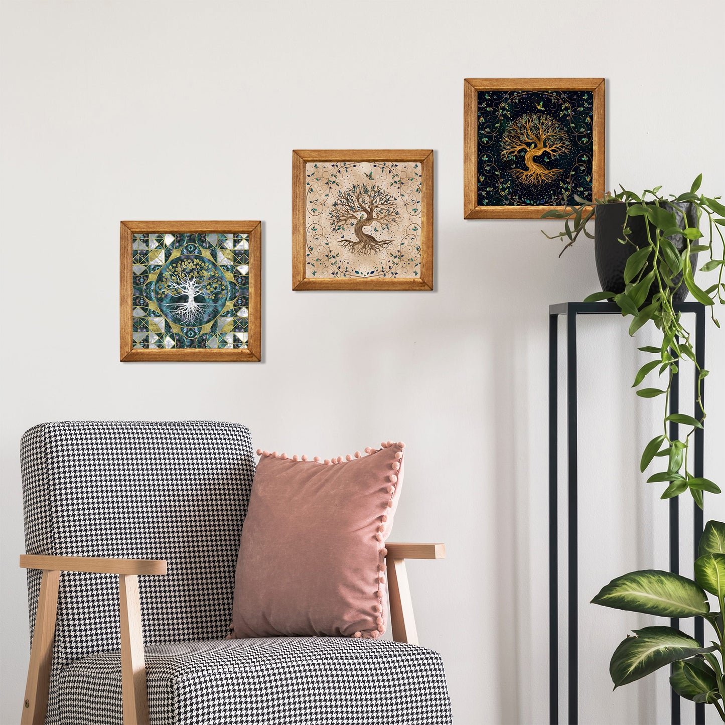 Framed artworks on a wall above a chair with a pink pillow.