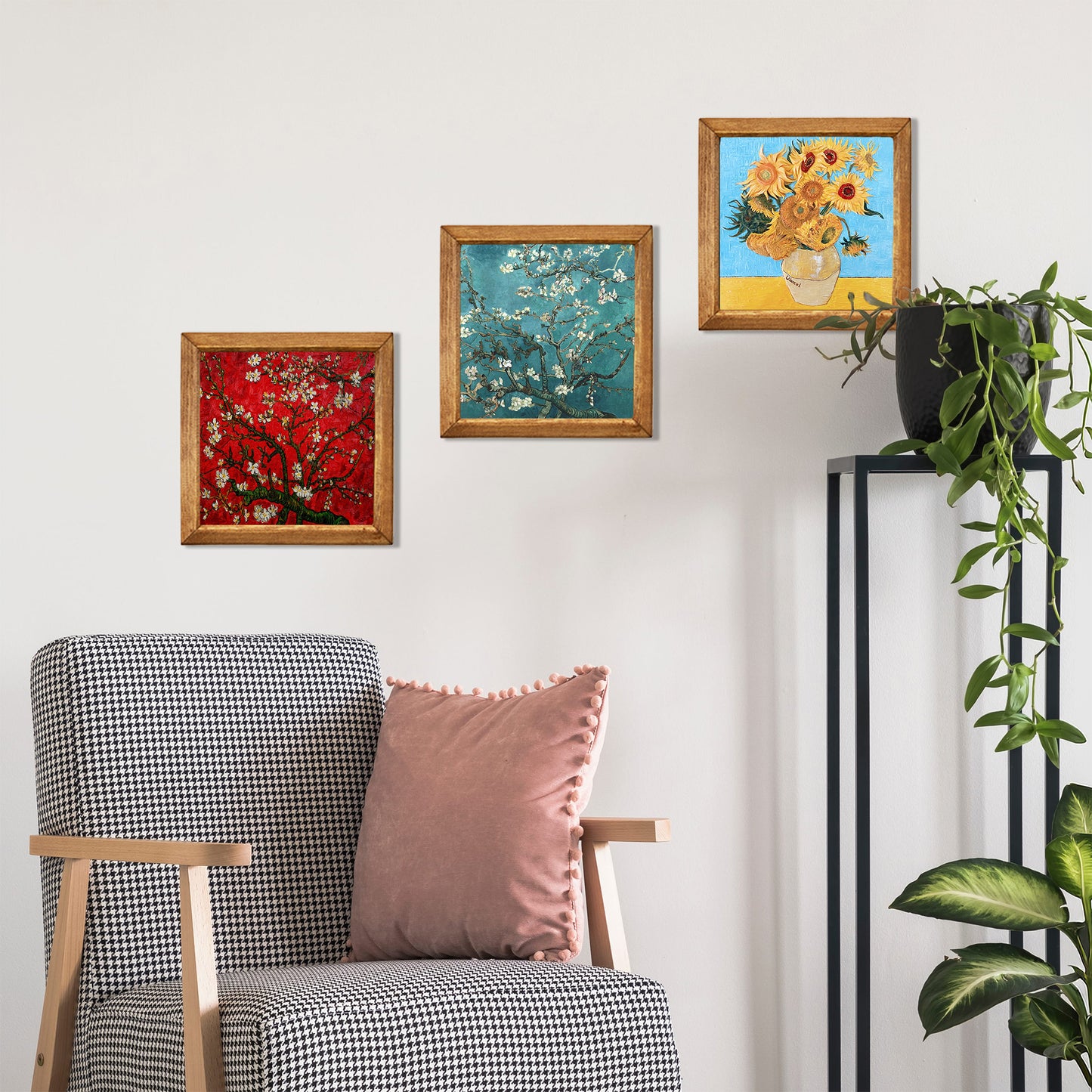 Decorative wall with framed artworks and a chair with cushions.