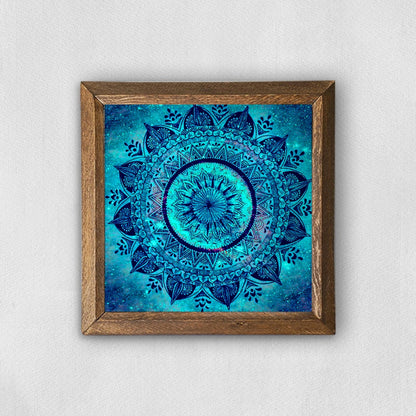 Framed blue mandala art on a white wall