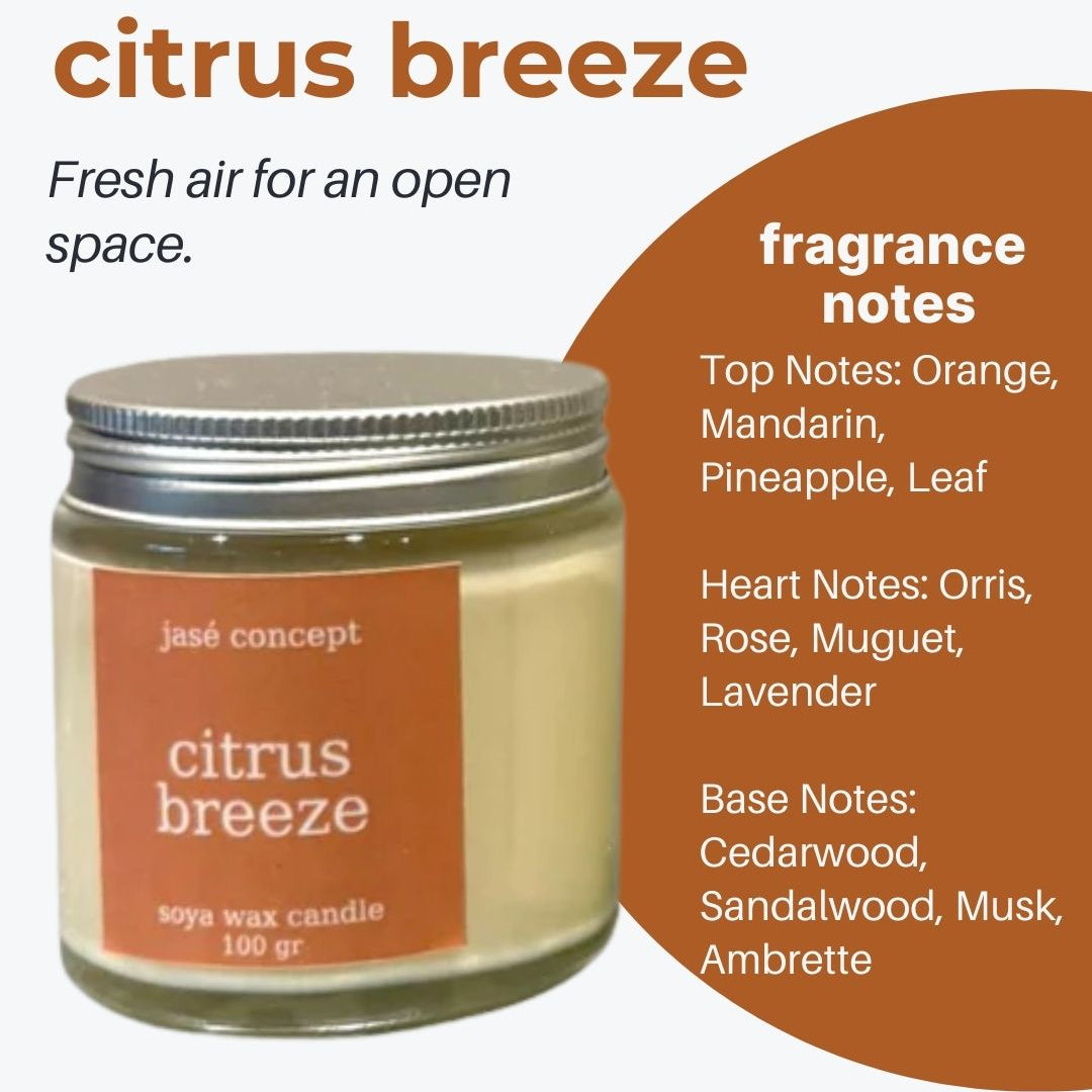 Candle jar labeled 'citrus breeze' with fragrance notes on an orange and white background