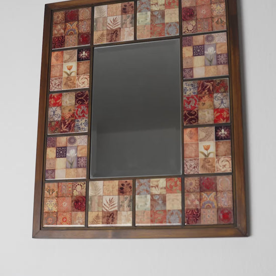 Handmade wall mirror with ceramic mosaic tiles and wooden frame, shown at an angle to highlight depth and craftsmanship, artistic home decor mirror