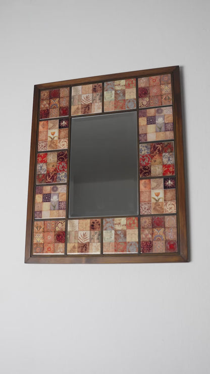 Handmade wall mirror with ceramic mosaic tiles and wooden frame, shown at an angle to highlight depth and craftsmanship, artistic home decor mirror
